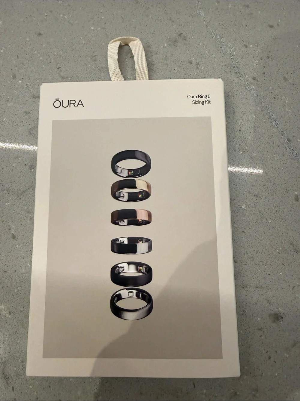 Oura Ring Sizing Kit with Black and Rose Gold Ring Images